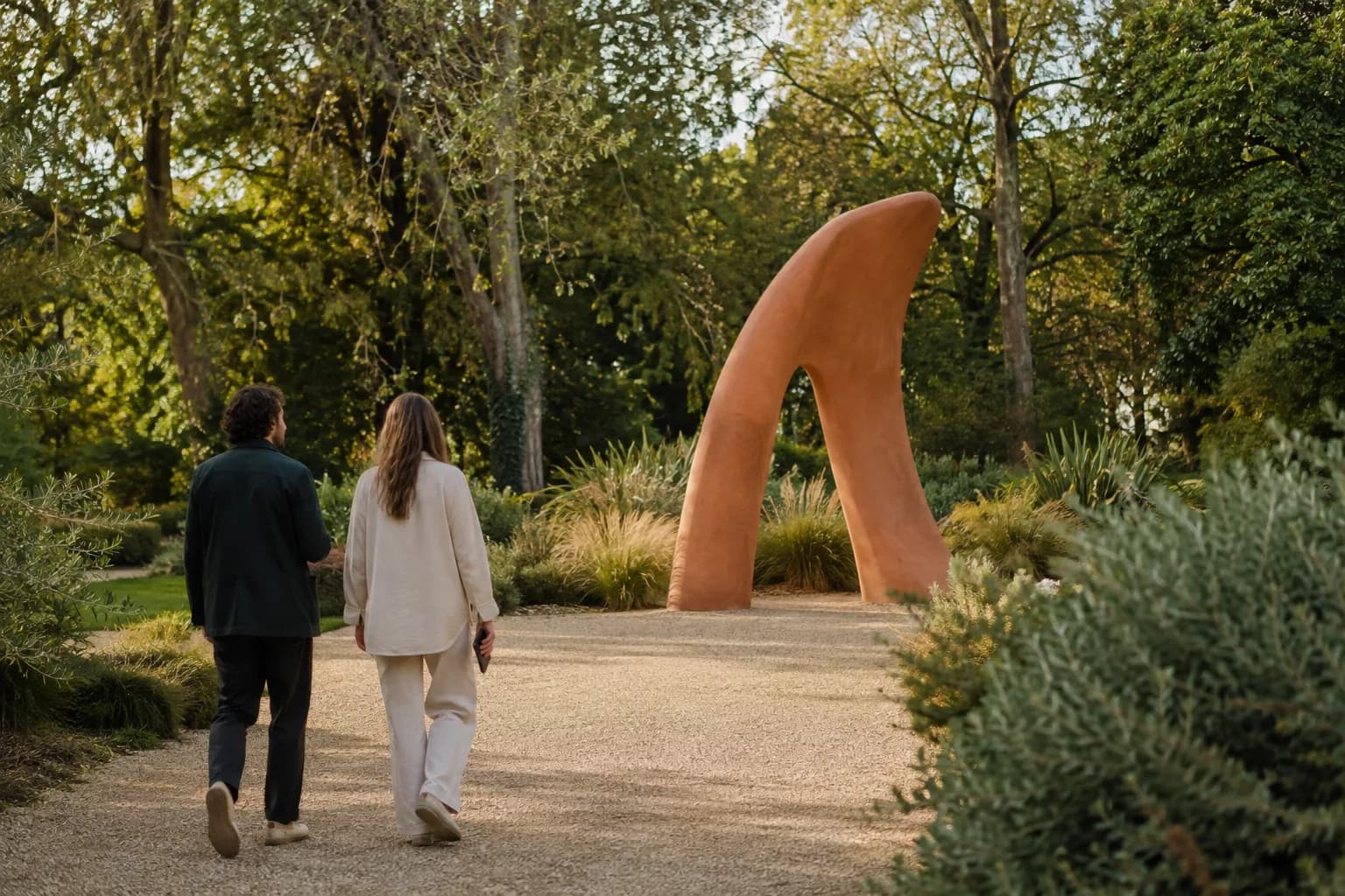 Illustrative scene of visitors approaching a sculpture in a garden